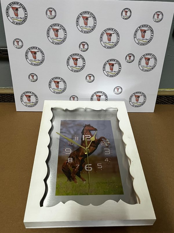A wall clock with a printed horse photograph inside a scalloped white wooden frame