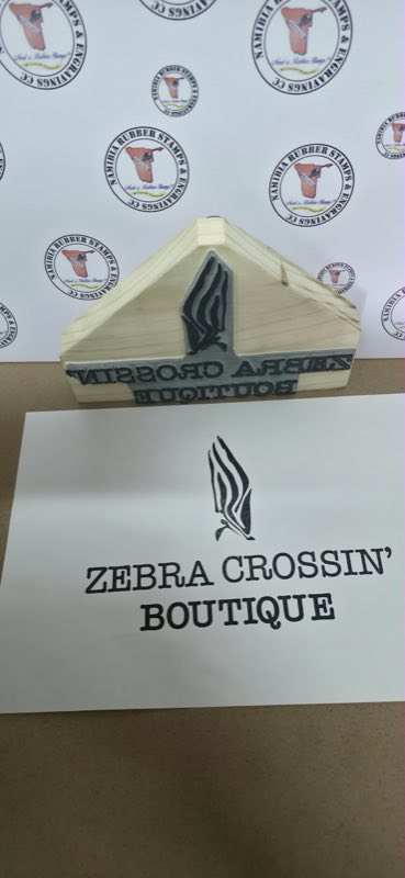 Custom die-cut wooden hand stamp for Zebra Crossin' Boutique, shown beside the impression it makes
