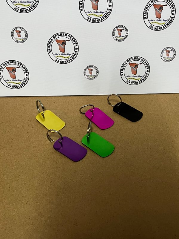 Five anodised aluminium keyring tags in yellow, purple, pink, green and black