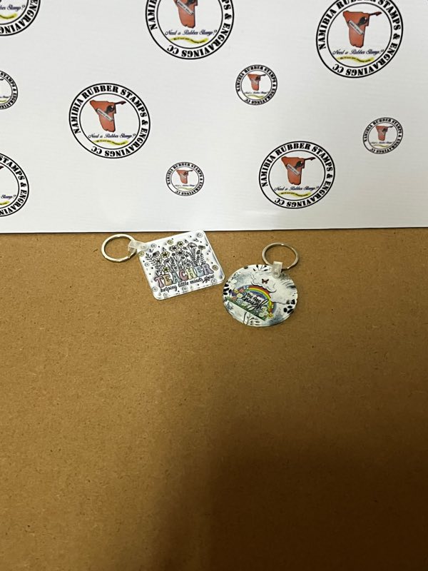 Two printed acrylic keyrings, one square and one round, with full-colour designs