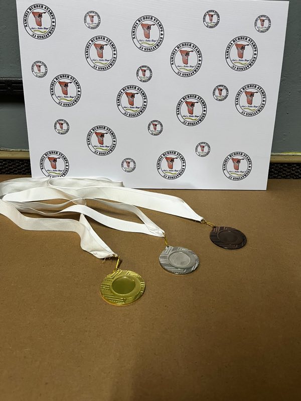 Gold, silver and bronze medals on white ribbons