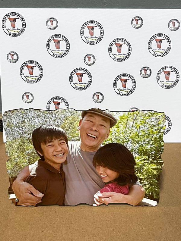 A family photograph printed onto a wooden panel with a decorative cut edge