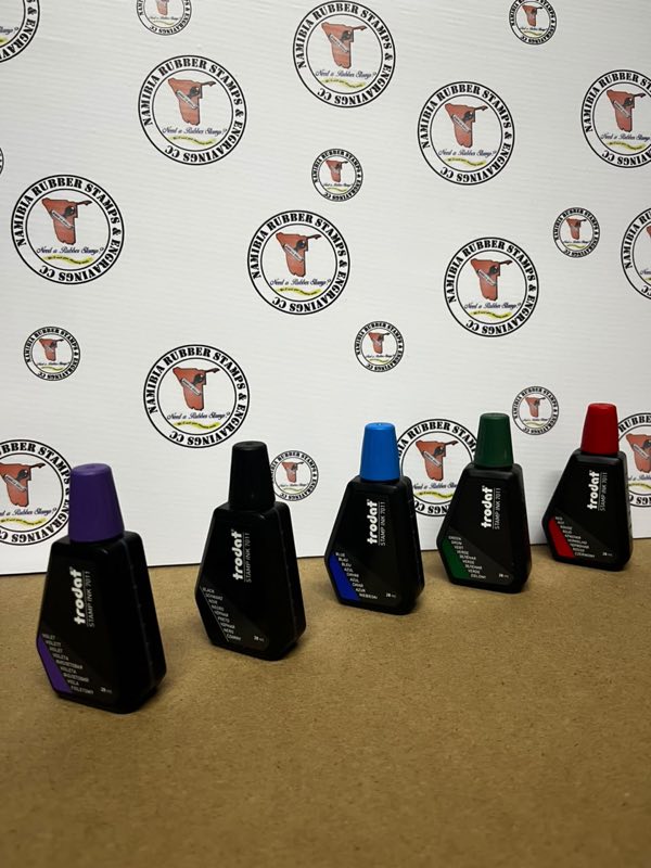 Five 28ml bottles of Trodat 7011 stamp ink in violet, black, blue, green and red