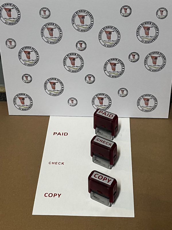 Three red self-inking stock stamps — PAID, CHECK and COPY — beside the impressions they make